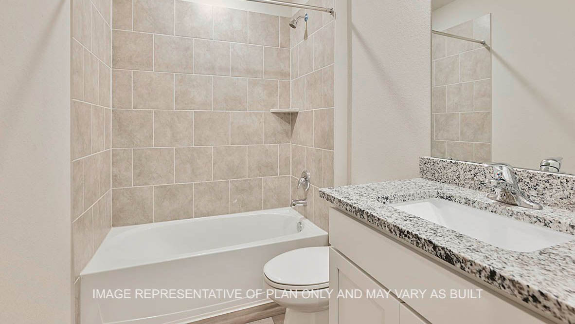 Texas Cali secondary bathroom with white cabinets, granite countertops, ceramic tile shower surround and vinyl plank flooring.