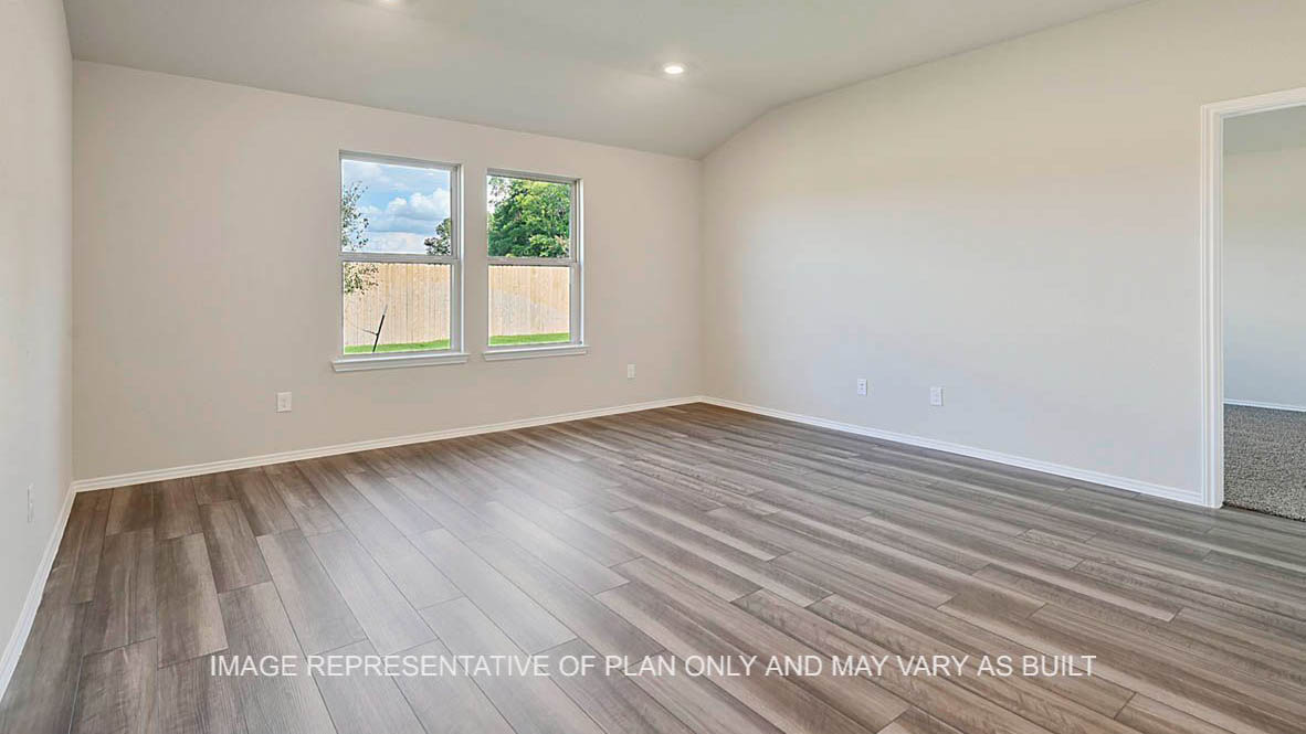 Texas Cali living room with windows and vinyl plank flooring.