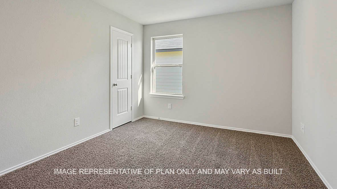 Texas Cali secondary bedroom with window and carpet flooring.