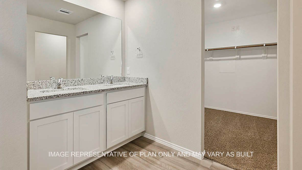 Texas Cali primary bathroom with entry to primary closet with carpet flooring.