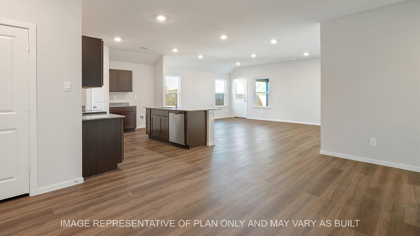 Lakeway open-concept dining with view to kitchen and living.