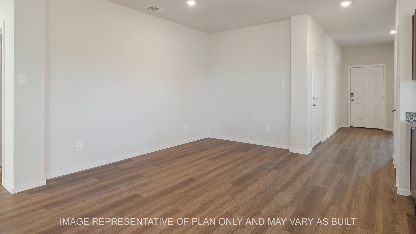 Lakeway open-concept dining with vinyl plank flooring and view to entryway.