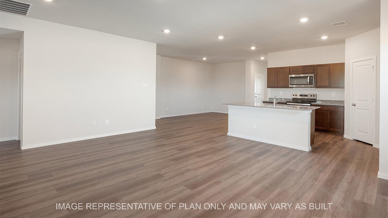 Lakeway open-concept living room with view to dining and kitchen.