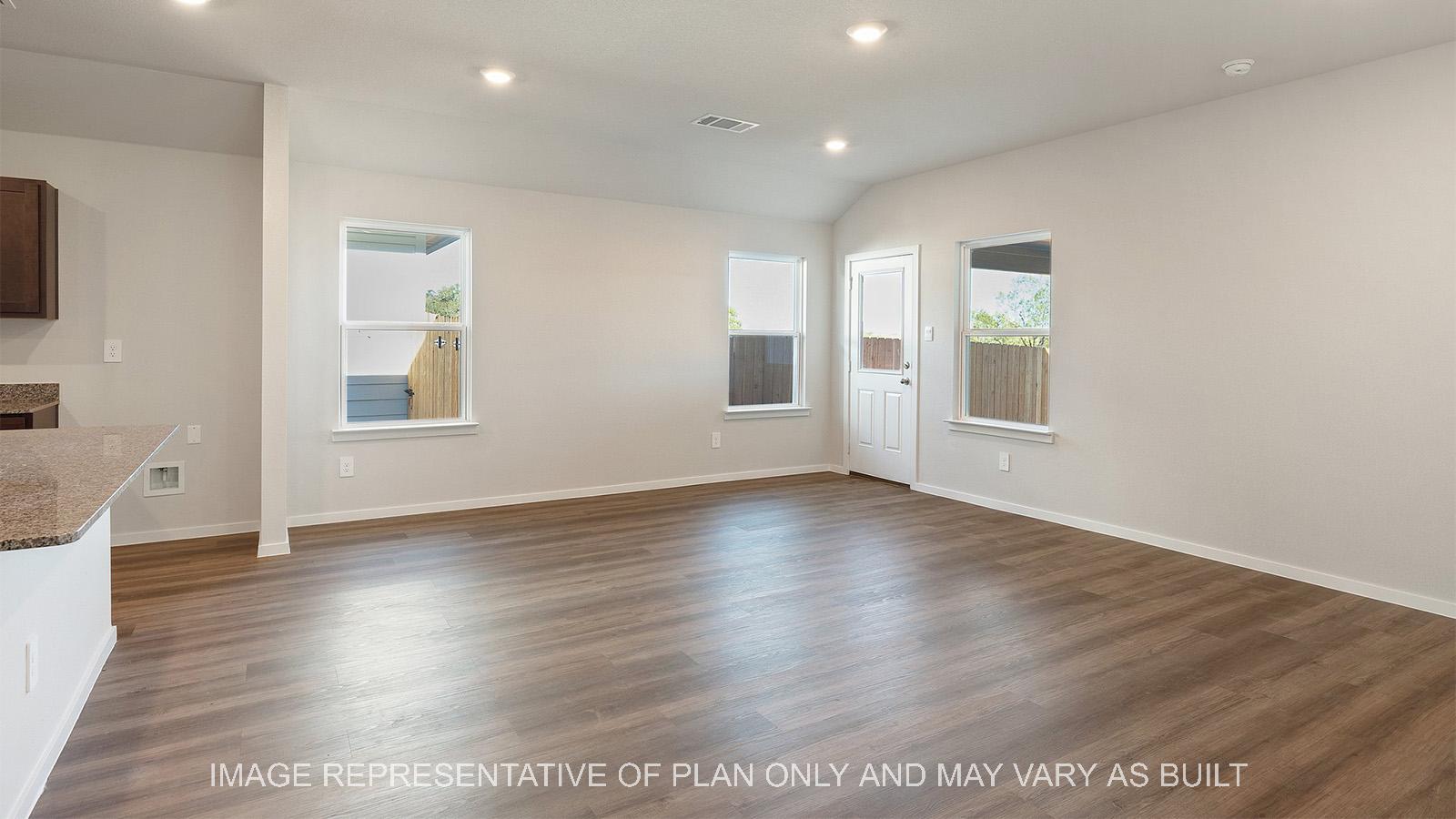 Lakeway open-concept living room with windows and back door.