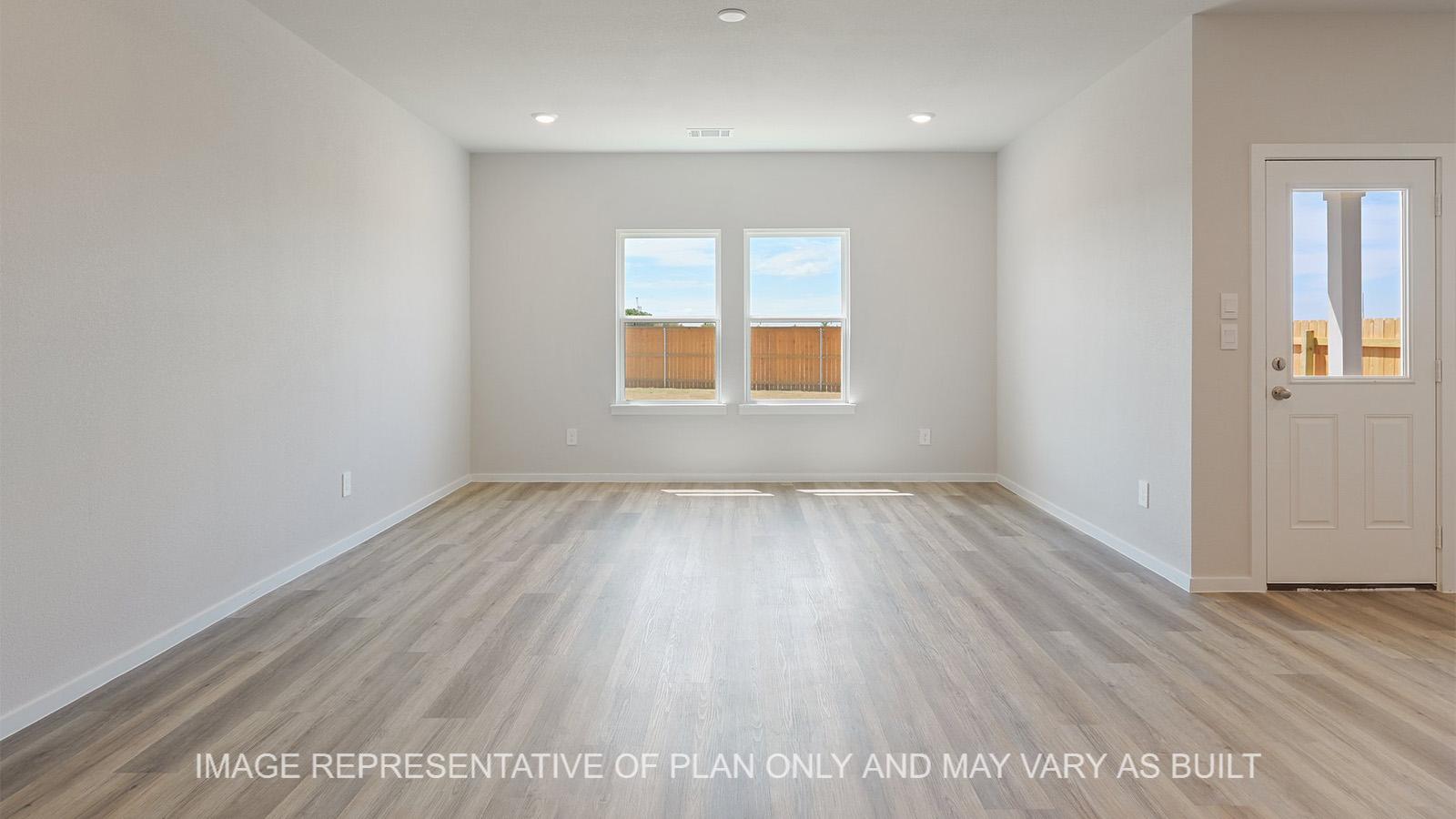 Midland open-concept living room with windows and vinyl plank flooring.