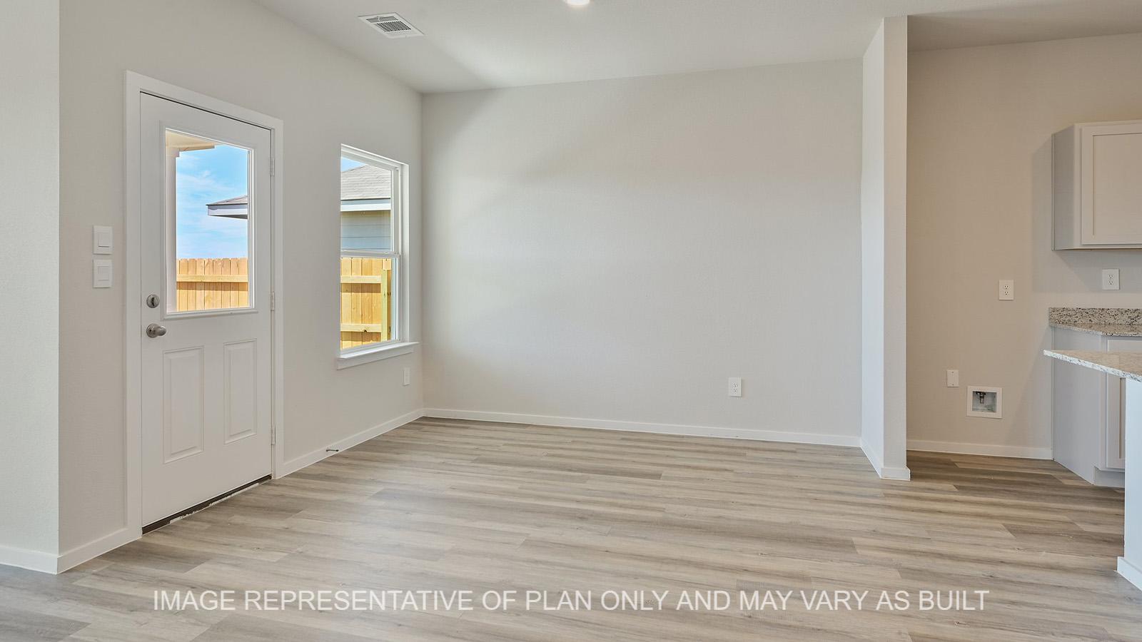 Midland open-concept dining room with window, back door, and vinyl plank flooring.