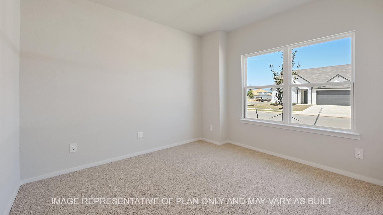 Midland secondary bedroom with windows and carpeted flooring.