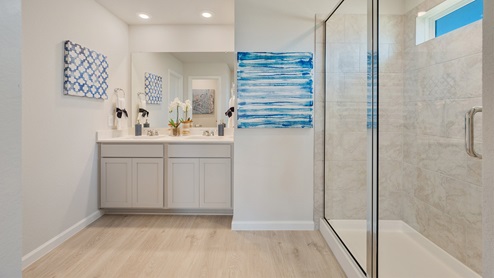 Liberty Village primary bathroom with quartz dual vanity and light gray cabinetry.