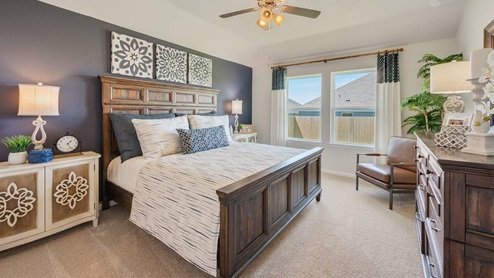 Liberty Village primary bedroom with carpeted flooring and navy accent wall.