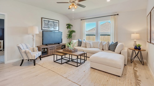 Liberty Village open concept living room with natural lighting and oversized sofa.