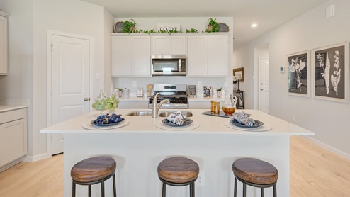 Liberty Village kitchen with barstools and quartz countertops.