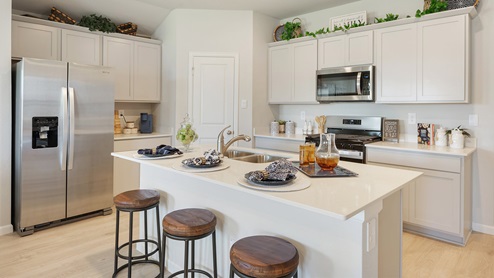Liberty Village kitchen with barstools and quartz countertops.