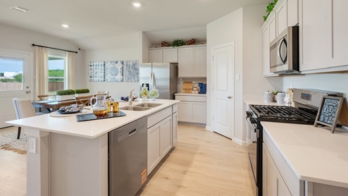 Liberty Village kitchen with stainless steel appliances and view to dining.