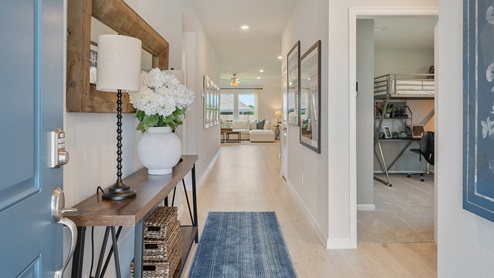 Liberty Village model entry with console and view to living space.