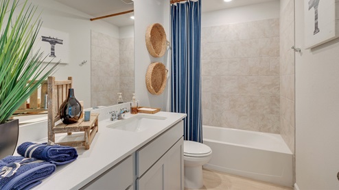 Liberty Village secondary bathroom with quartz vanity and shower/tub combo.