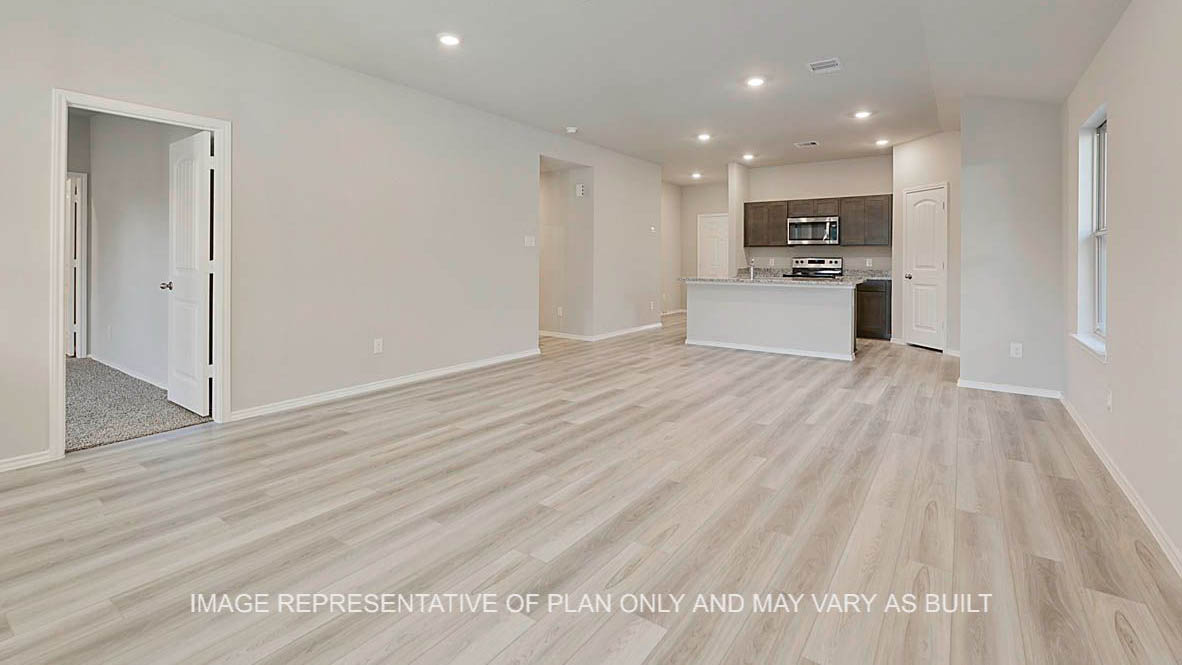 Elgin open-concept living room with vinyl plank flooring and view to kitchen.