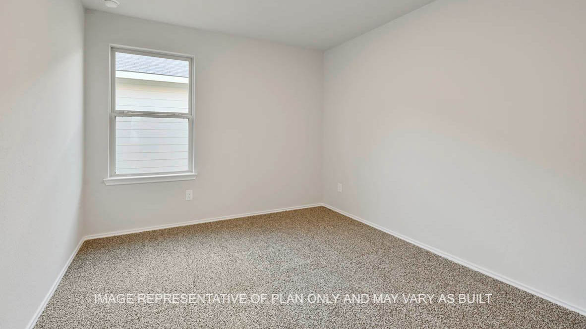 Elgin secondary bedroom with window and carpeted flooring.