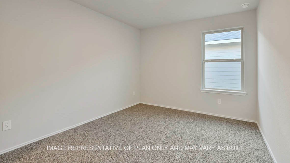Elgin secondary bedroom with window and carpeted flooring.