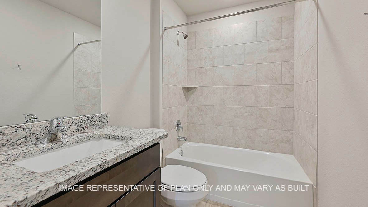 Elgin secondary bathroom with dark stained cabinetry, granite countertops, ceramic tile shower bath surround, and vinyl plank flooring.