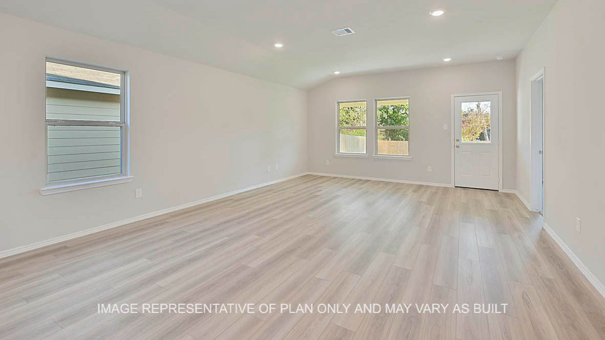 Elgin open-concept living room with windows, vinyl plank flooring, and view to back door.