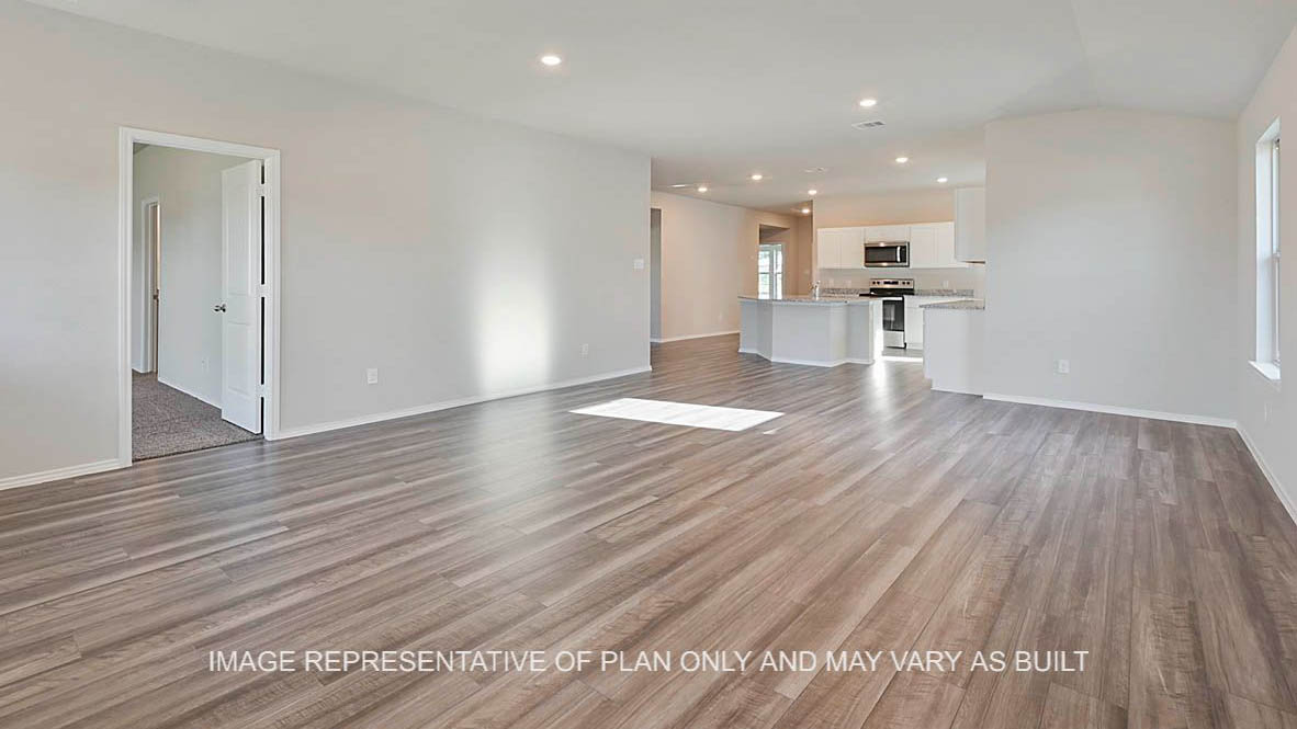 Kingston open-concept living room with view to kitchen and vinyl plank flooring.