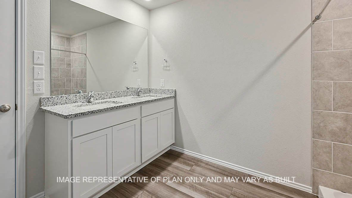 Kingston primary bathroom with white cabinetry, granite countertops, ceramic tile shower surround, and vinyl plank flooring.