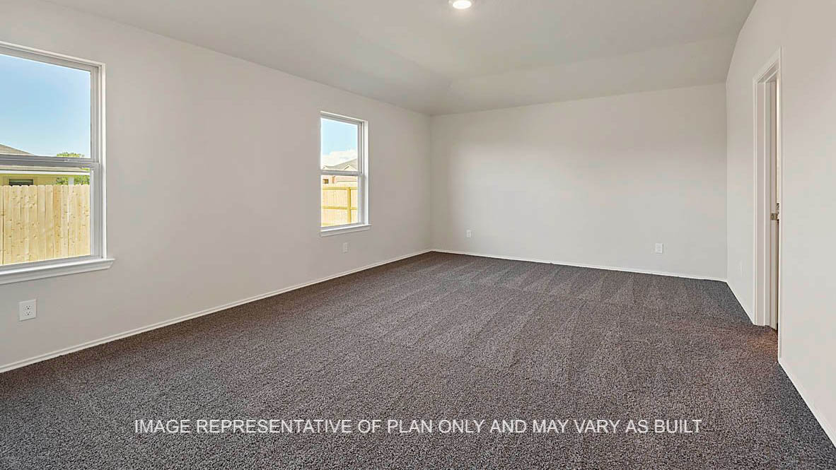 Kingston primary bedroom with windows, carpeted flooring, and view to bathroom.