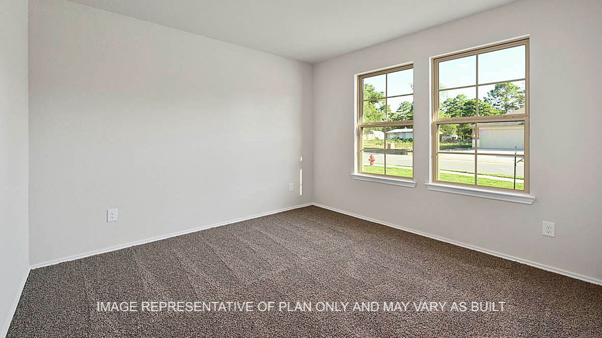 Kingston secondary bedroom with windows and carpeted flooring.