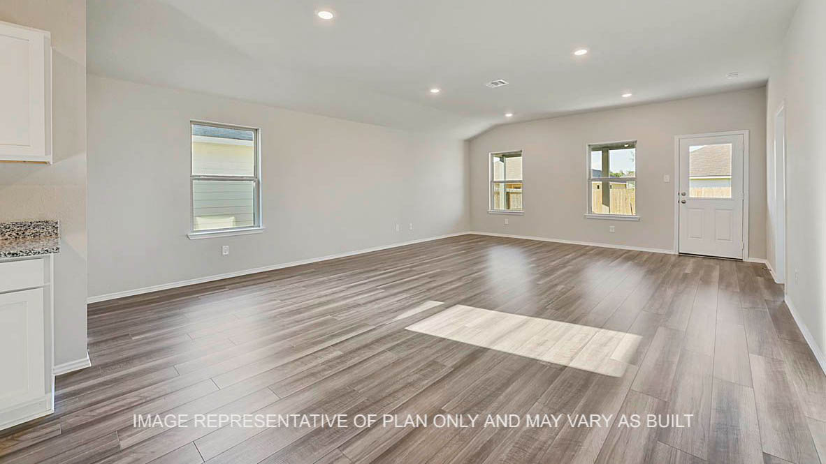 Kingston open-concept kitchen with view to backyard and vinyl plank flooring.