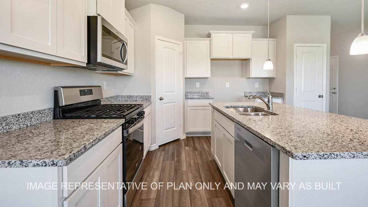 Auburn kitchen with white cabinets, granite countertops and vinyl plank flooring.