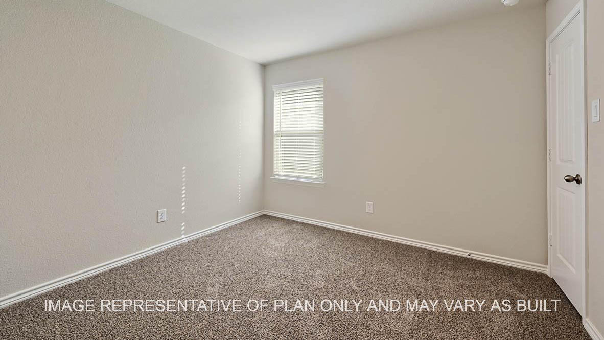 Auburn secondary bedroom with window, carpet flooring and closet access.