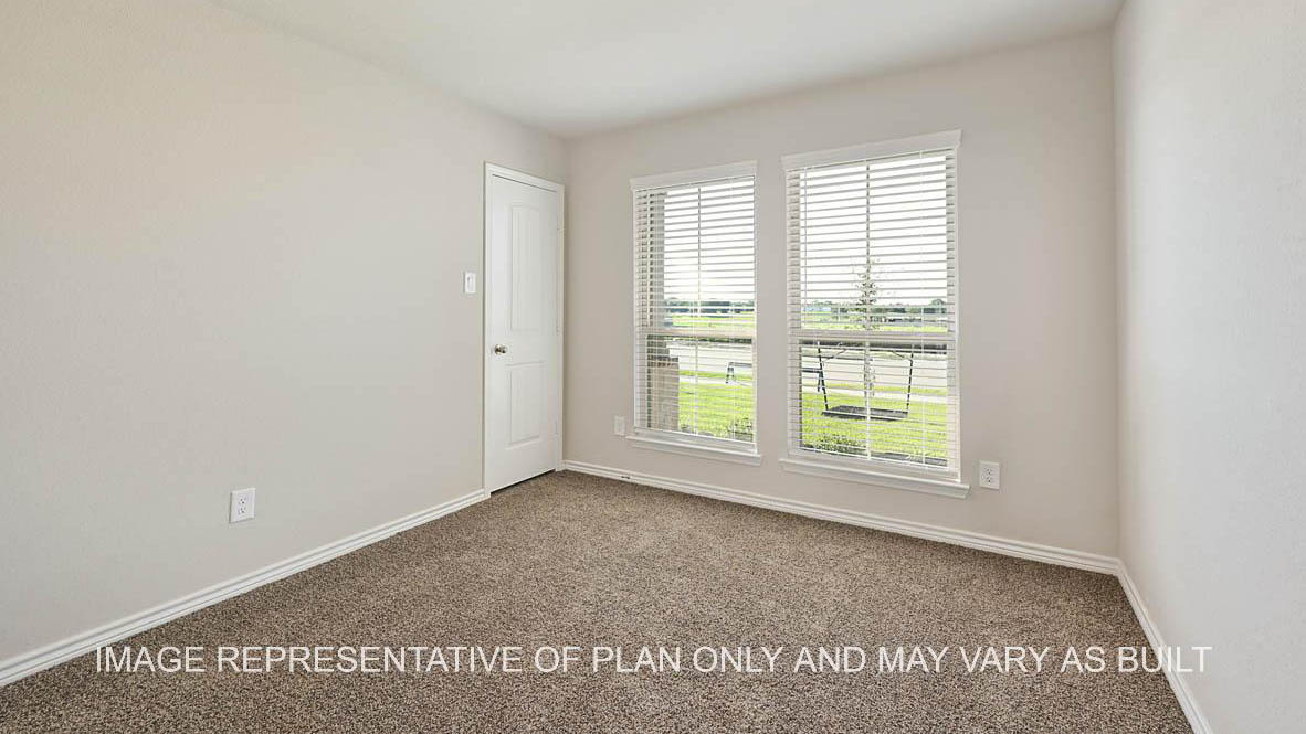 Auburn secondary bedroom with two front-facing windows, carpet flooring, and closet access.