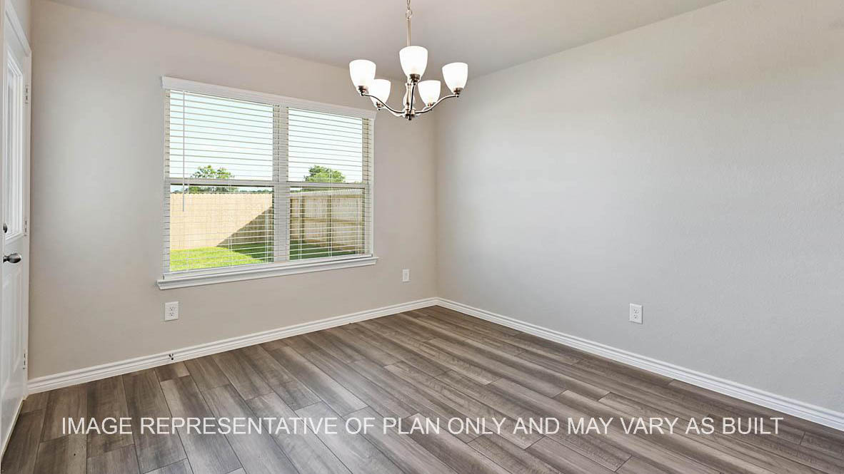 Auburn open-concept dining room with back door, window with a view to the backyard, and vinyl plank flooring.