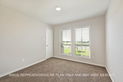 Auburn secondary bedroom with two front-facing windows, carpet flooring, and closet access.