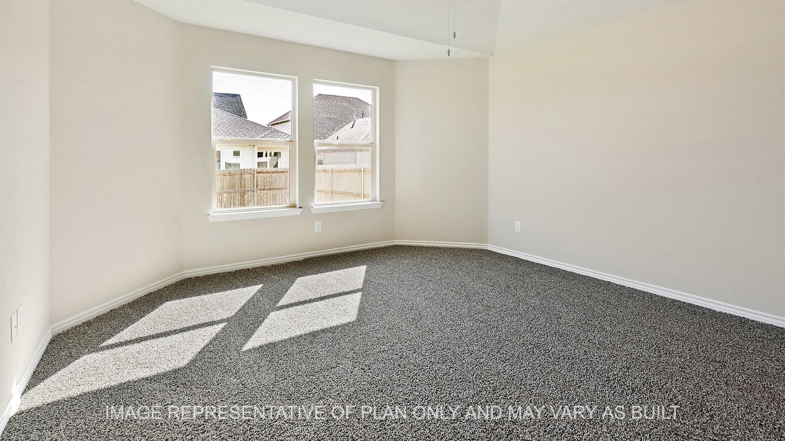 Alpine primary bedroom with windows and carpeted flooring.