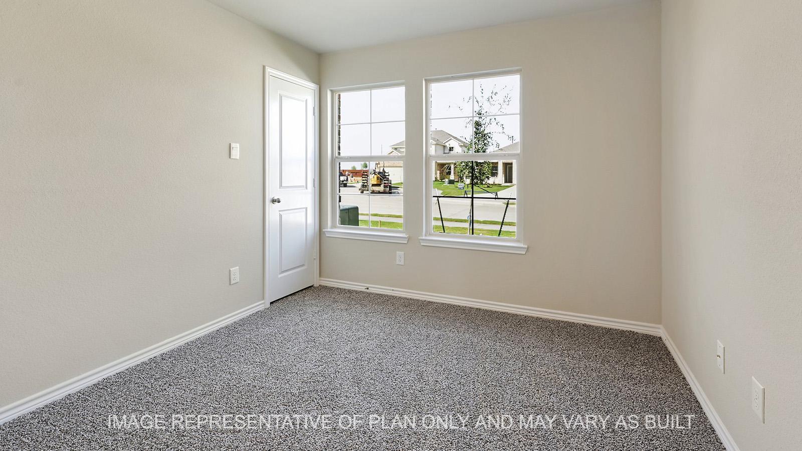 Alpine secondary bedroom with windows and carpeted flooring.
