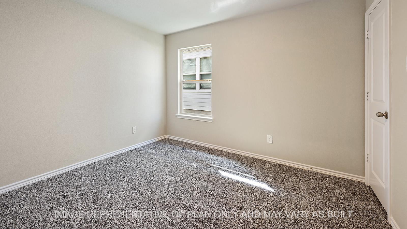 Alpine secondary bedroom with window and carpeted flooring.