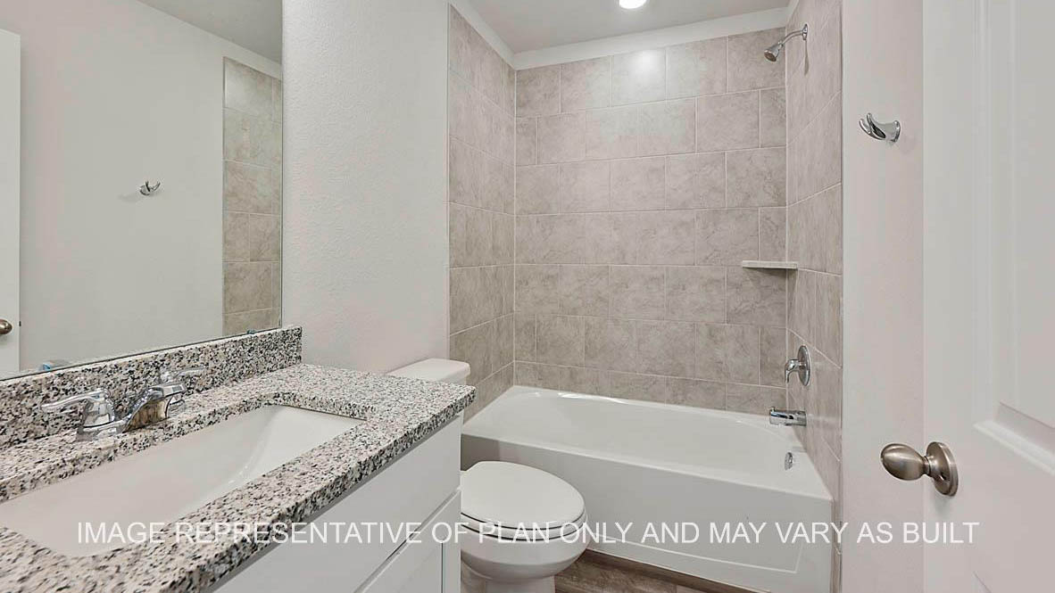 Roosevelt secondary bathroom with white cabinets, granite countertops, ceramic tile shower surround and vinyl plank flooring.