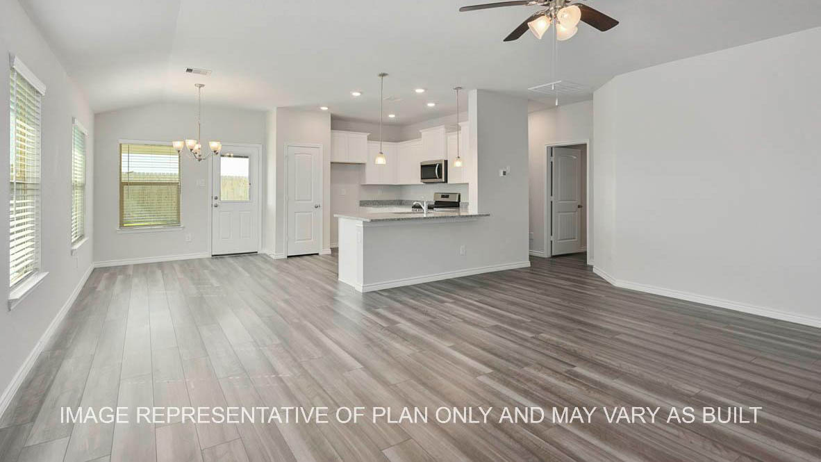 Roosevelt kitchen with white cabinets, granite countertops and gray vinyl plank flooring.