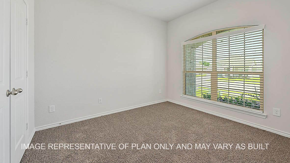 Roosevelt secondary bedroom with window and carpet flooring.
