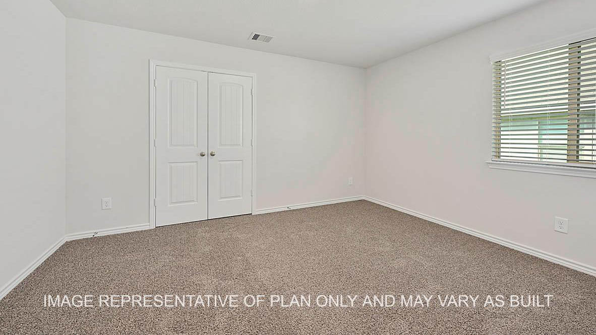 Roosevelt secondary bedroom with window and carpet flooring.