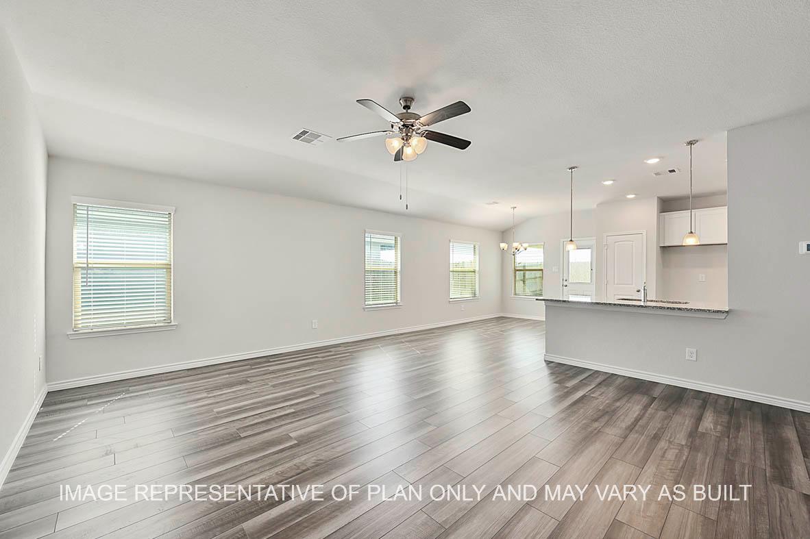 Roosevelt living room with white cabinets, granite countertops and gray vinyl plank flooring.
