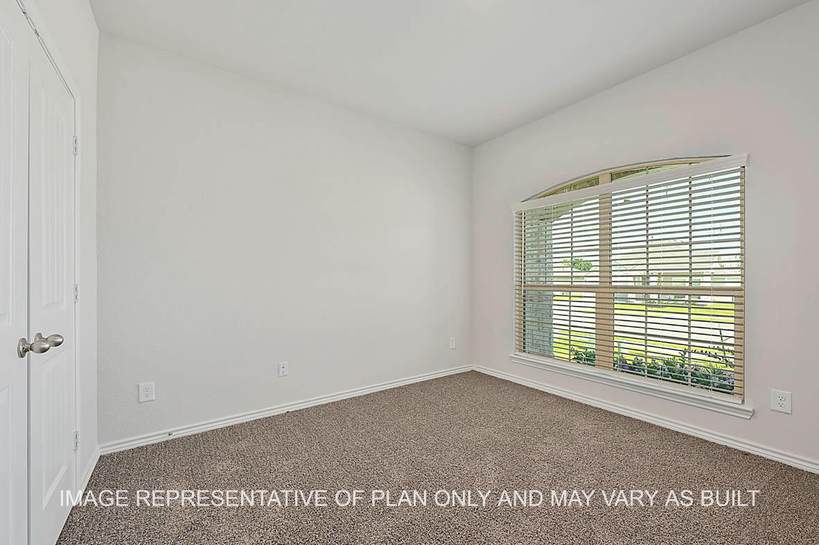Roosevelt secondary bedroom with window and carpet flooring.