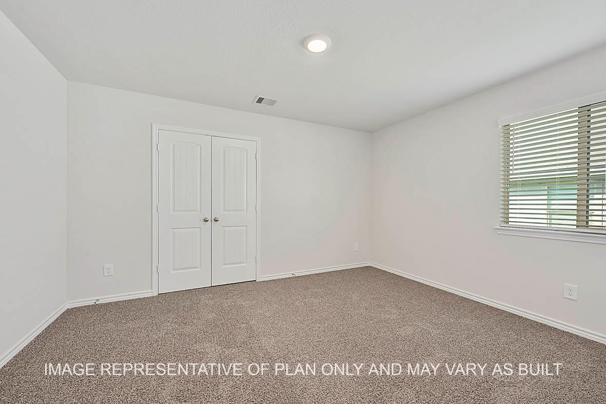Roosevelt secondary bedroom with window and carpet flooring.