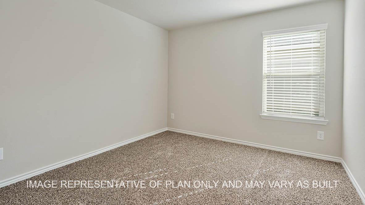 Richmond secondary bedroom with window and carpet flooring.
