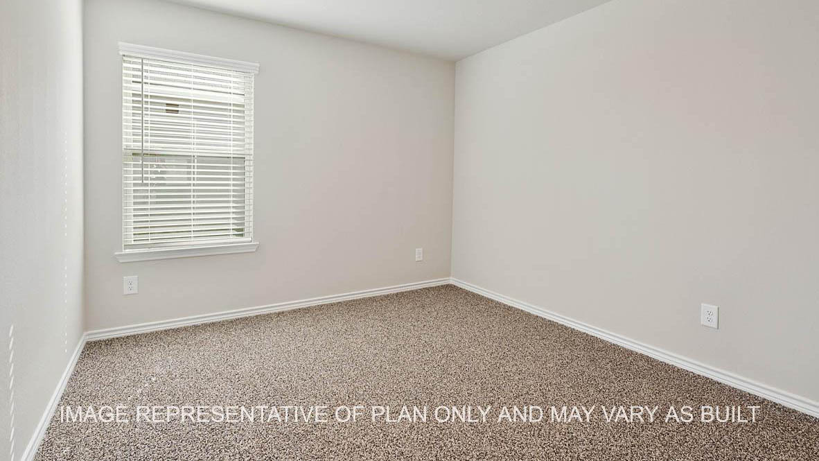 Richmond secondary bedroom with window and carpet flooring.
