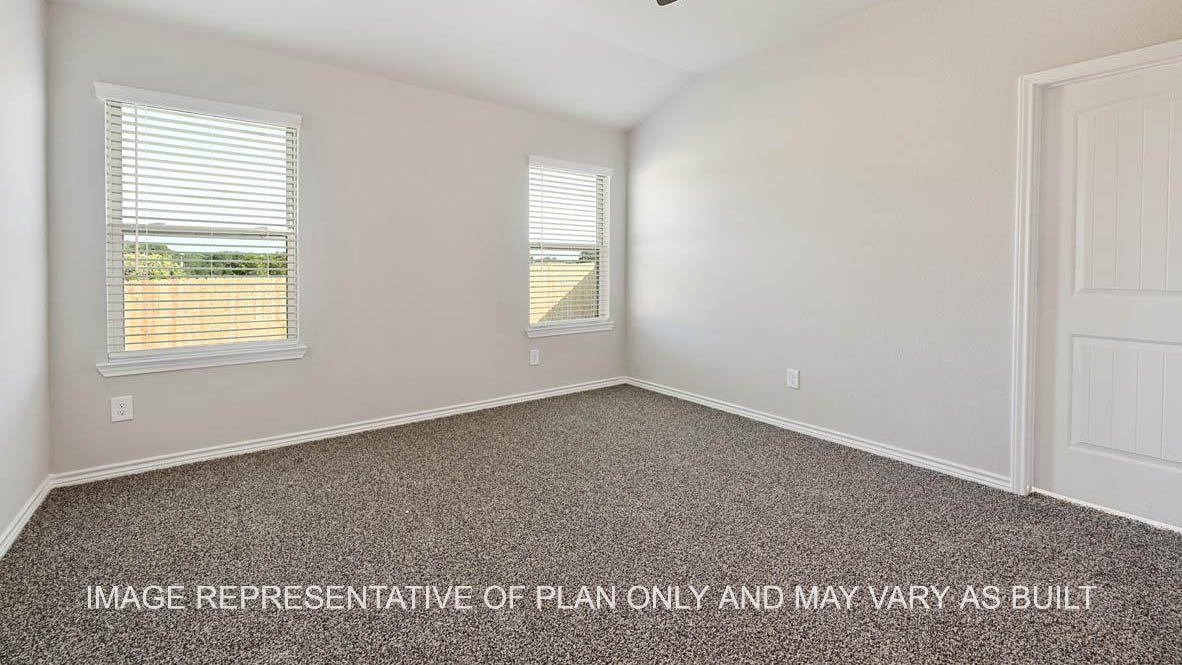 Richmond primary bedroom with carpet flooring and two windows.