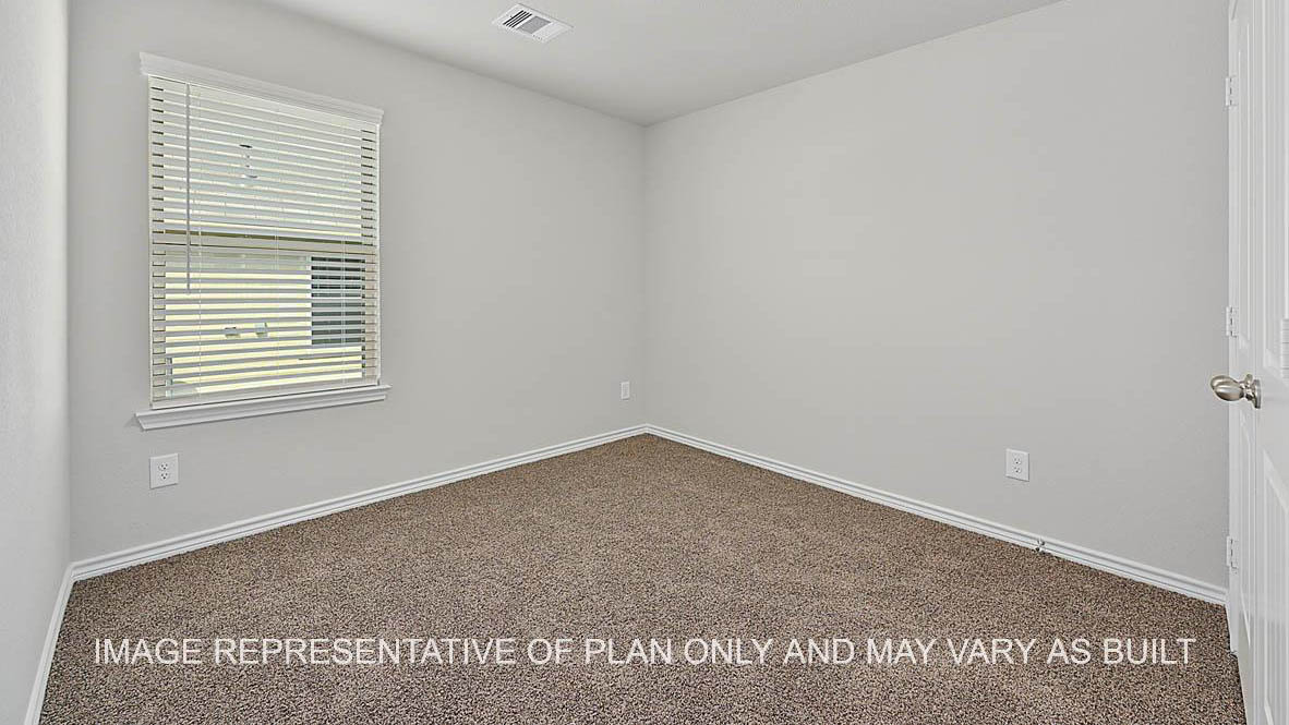 Prescott secondary bedroom with window and carpet flooring.