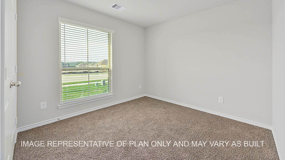 Prescott secondary bedroom with window and carpet flooring.