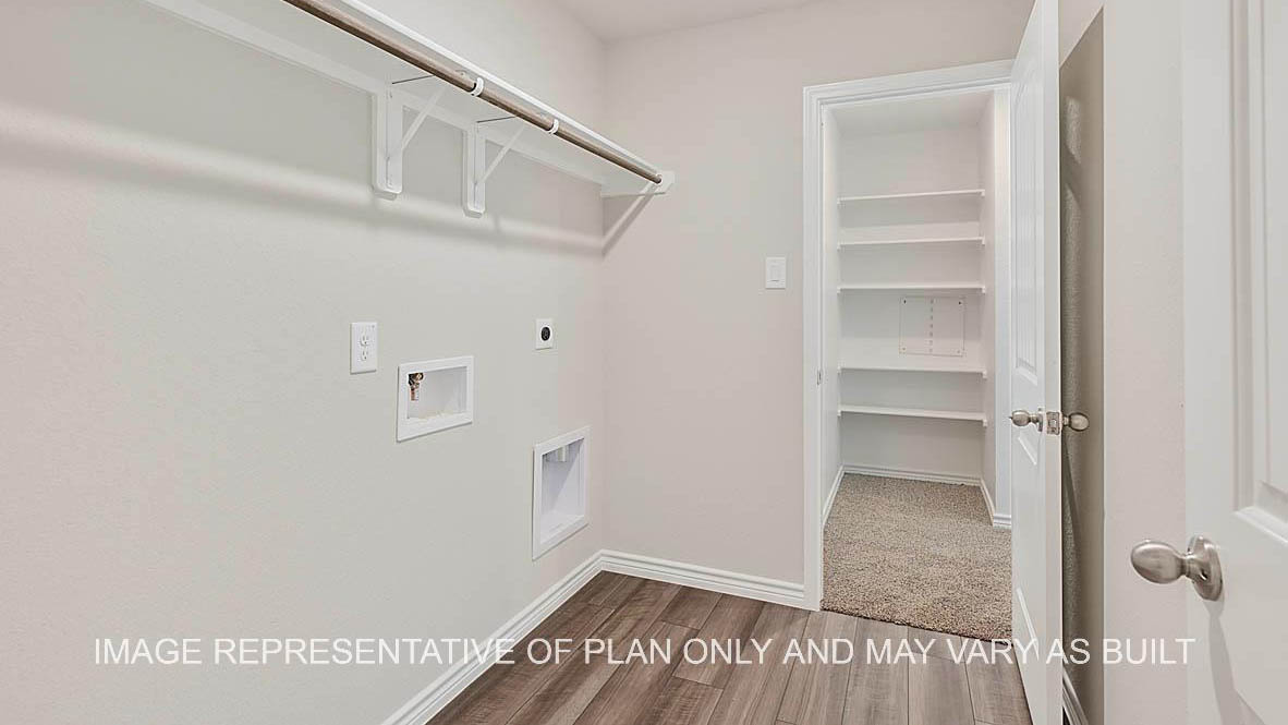 Prescott utility room with vinyl flooring and view to primary closet.